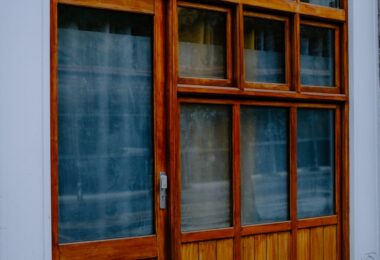 Wooden storefront with large glass windows, illustrating a Shopio review and store builder alternatives