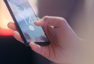 Hand holding a smartphone locked with a fingerprint sensor, protecting accounts from Instagram+ mod risks