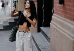 Young woman filming herself on a smartphone in the city, creating content to grow the most followers on Instagram