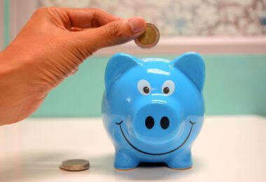 Person putting a coin in a piggy bank, a symbol of ways to make money online for free