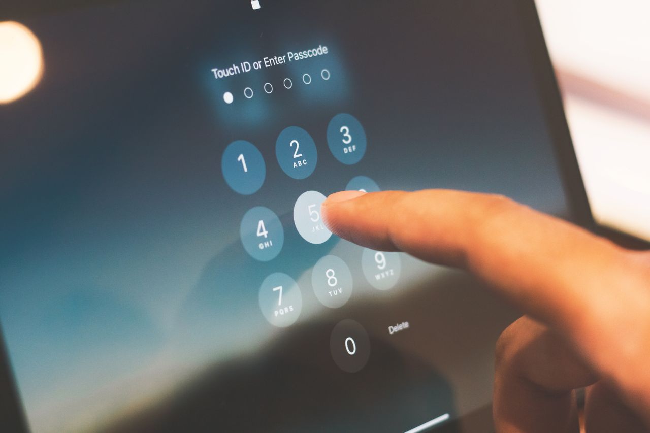 Finger entering a passcode on a smartphone, securing an account after using an Instadownloader tool