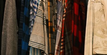 Rack of colorful men's casual shirts in plaid and stripes, ideas for colorful men's fashion