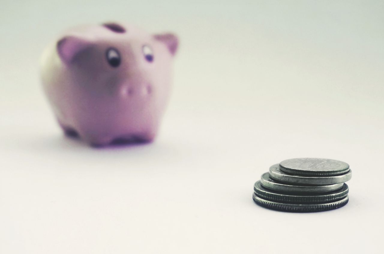 Coins and a piggy bank showing the small payouts from easy money online tasks