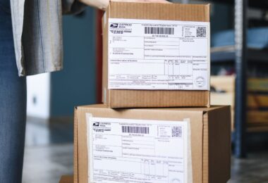 Stack of cardboard boxes with shipping labels ready to go out by standard shipping