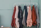 Clothes hanging on a rack in a boutique, ideas for how to start an online clothing store