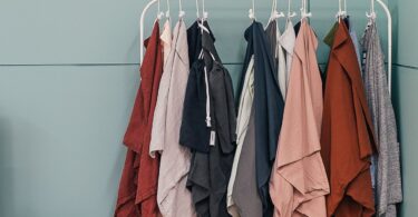 Clothes hanging on a rack in a boutique, ideas for how to start an online clothing store