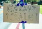Garage sale sign on a post; selling items you own is how to make money in one hour