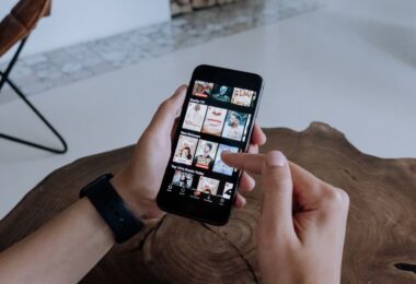Person browsing videos on a smartphone while deciding whether an Instagram video downloader online is safe