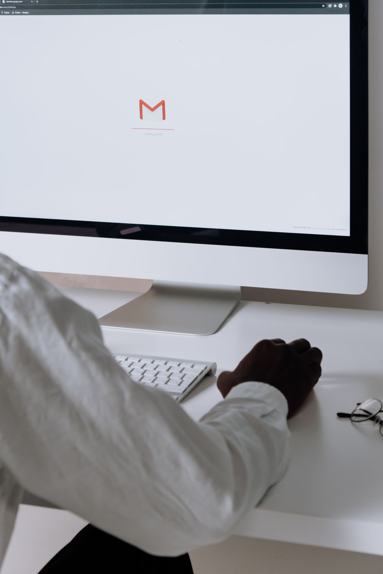 Professional checking email campaigns on a desktop computer, as covered in this MailerLite review