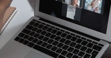 Laptop showing a group video call, like the webinars included in GetResponse plans reviewed for 2026