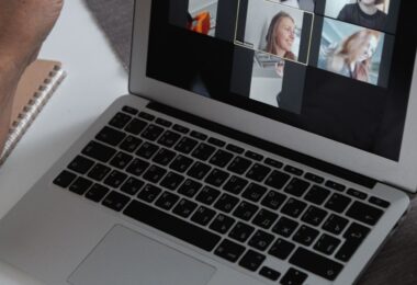 Laptop showing a group video call, like the webinars included in GetResponse plans reviewed for 2026