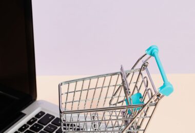 Miniature shopping cart on a laptop keyboard, illustrating the UltraCart hosted shopping cart review