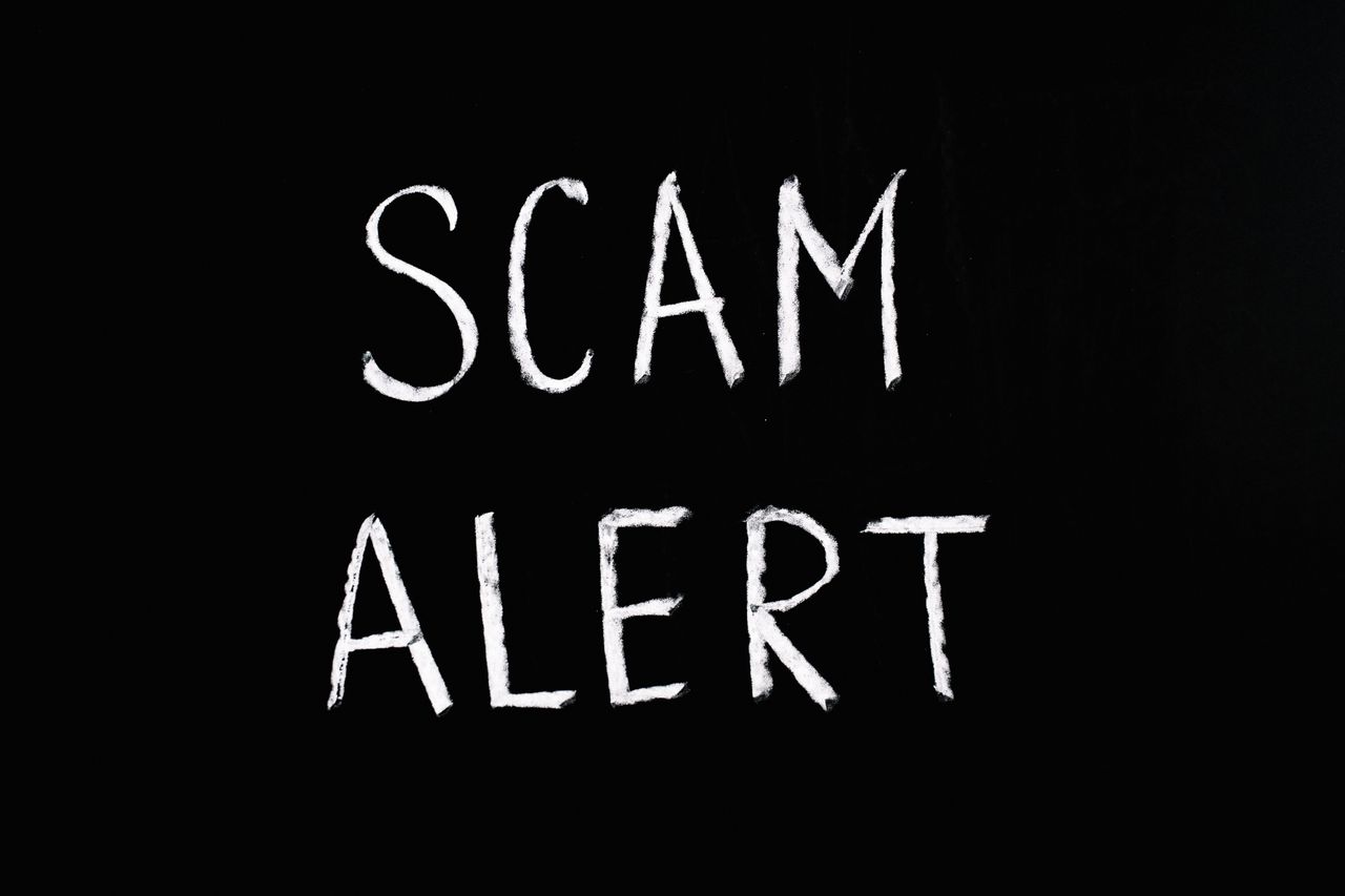 Scam alert letters on a dark background, a warning when looking for legit ways to make extra money from home