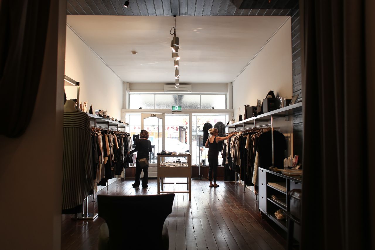 Customers browsing clothes in a boutique, the kind of physical shop EasyStore links to online sales