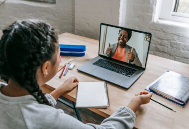 Student on a video call with a teacher on her laptop, one of many online jobs from home for students