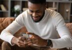 Man on a sofa using his smartphone to take online surveys for money