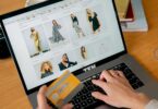 Woman paying by credit card in an online store on her laptop, for a 3DCart (now Shift4Shop) review