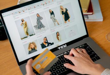 Woman paying by credit card in an online store on her laptop, for a 3DCart (now Shift4Shop) review