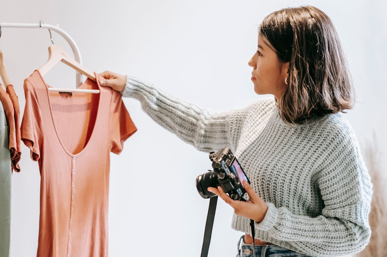 Woman choosing clothes to photograph for resale, a no-skill way to make money from home online