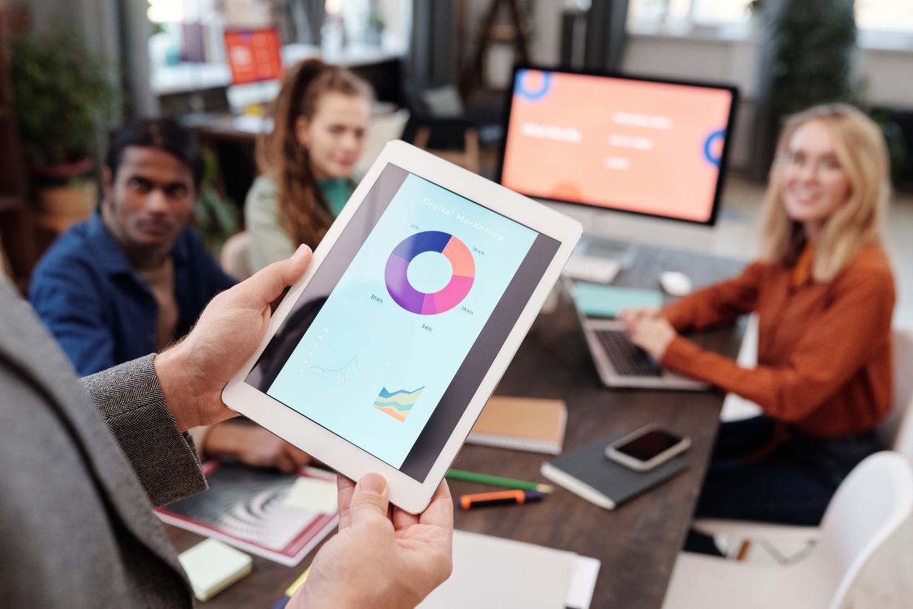 Tablet showing a digital marketing pie chart while creating a digital marketing strategy