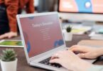 Person typing on a laptop, researching how to make money online on Quora
