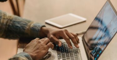 Freelancer working on a laptop at home, using top online earning sites to find paid work