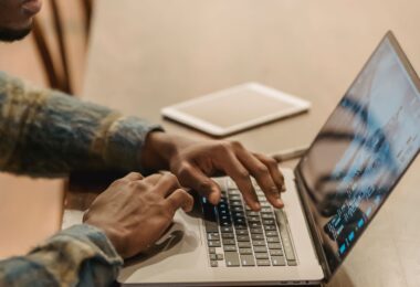 Freelancer working on a laptop at home, using top online earning sites to find paid work