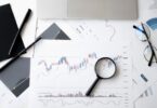 Magnifying glass on a document, symbolizing how to verify trusted online money making sites