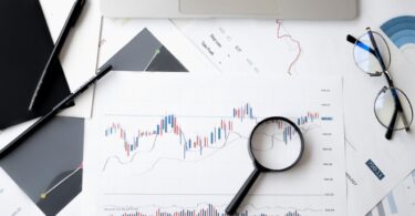 Magnifying glass on a document, symbolizing how to verify trusted online money making sites
