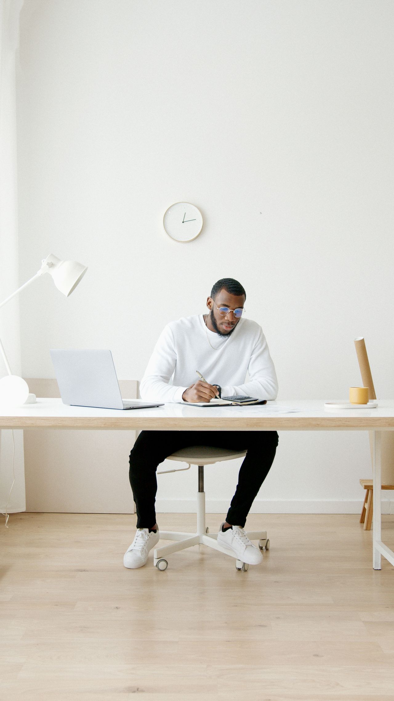 Professional working at a minimalist desk while launching an online business