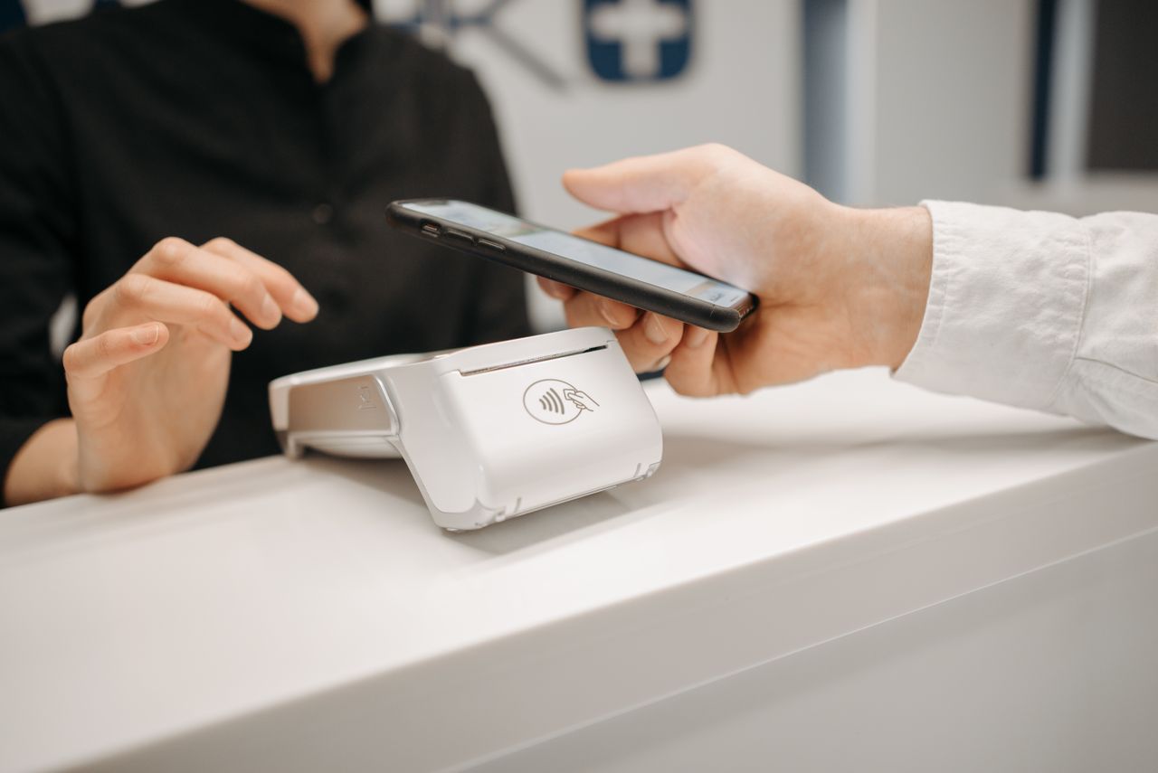 Person handling a payment on a smartphone, one way online work pay reaches you