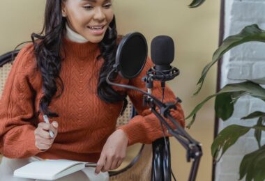Creator recording a podcast with a microphone and laptop, the audience ConvertKit (now Kit) is built for