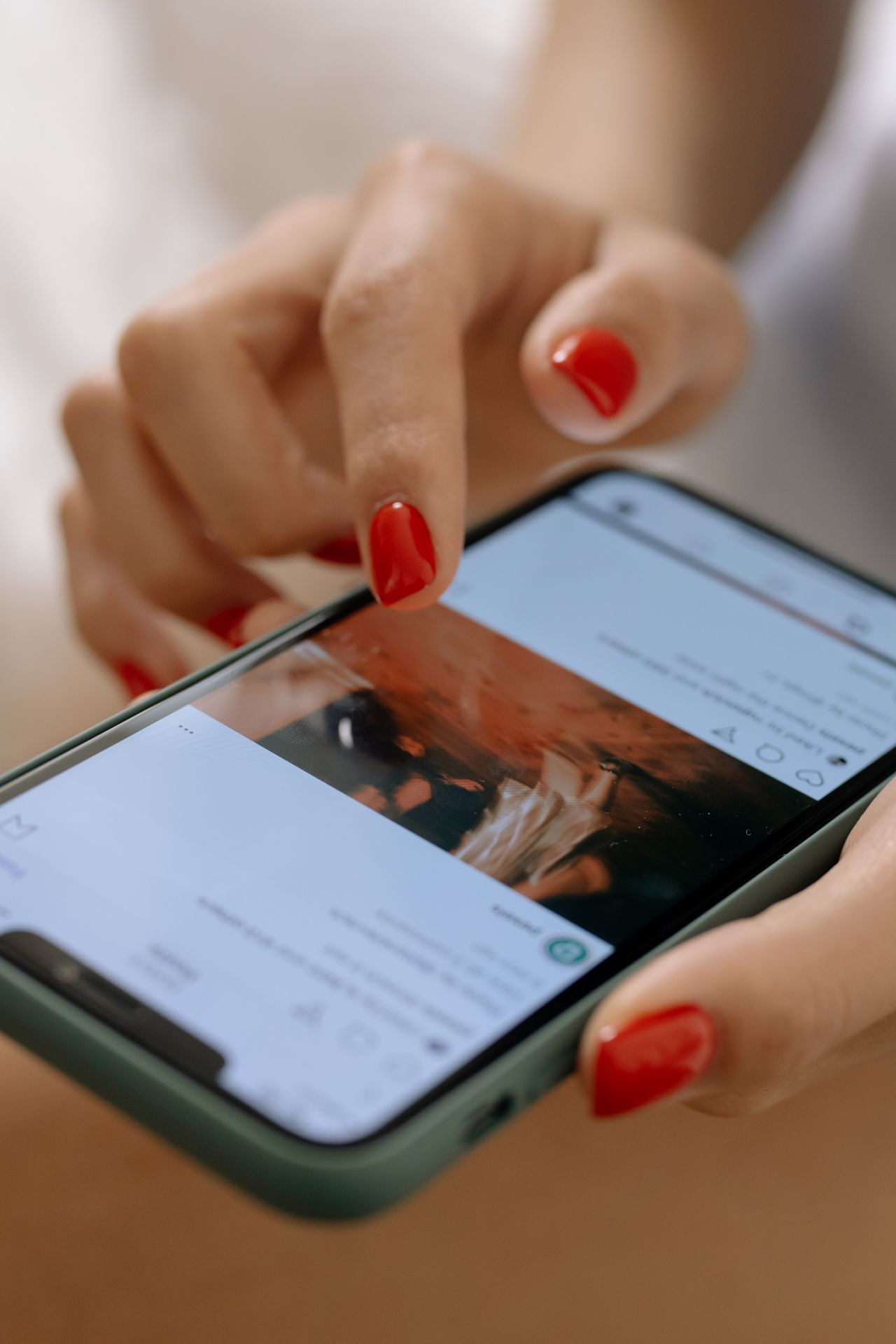 Woman scrolling a social media feed on her smartphone, checking accounts with the most Instagram followers
