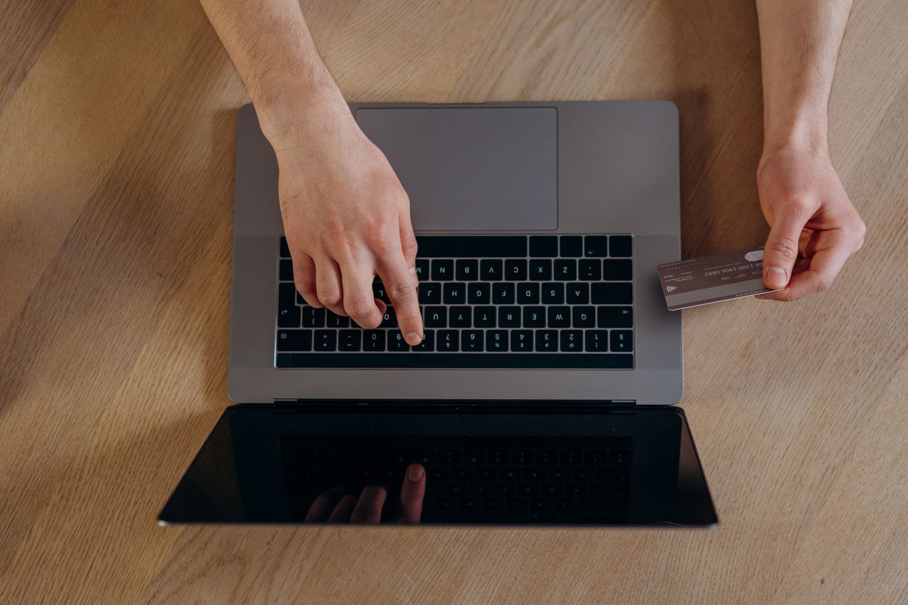 Person checking an online payment on a laptop after earning on top online earning sites