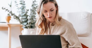Busy freelancer working on a laptop at home using the best online earning websites