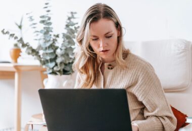 Busy freelancer working on a laptop at home using the best online earning websites