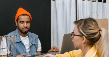 Customer paying by card at a fashion store counter, the in-store POS sales an EasyStore review covers
