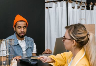 Customer paying by card at a fashion store counter, the in-store POS sales an EasyStore review covers