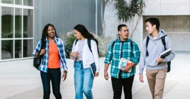 Group of college students walking on campus, where many online jobs for students start