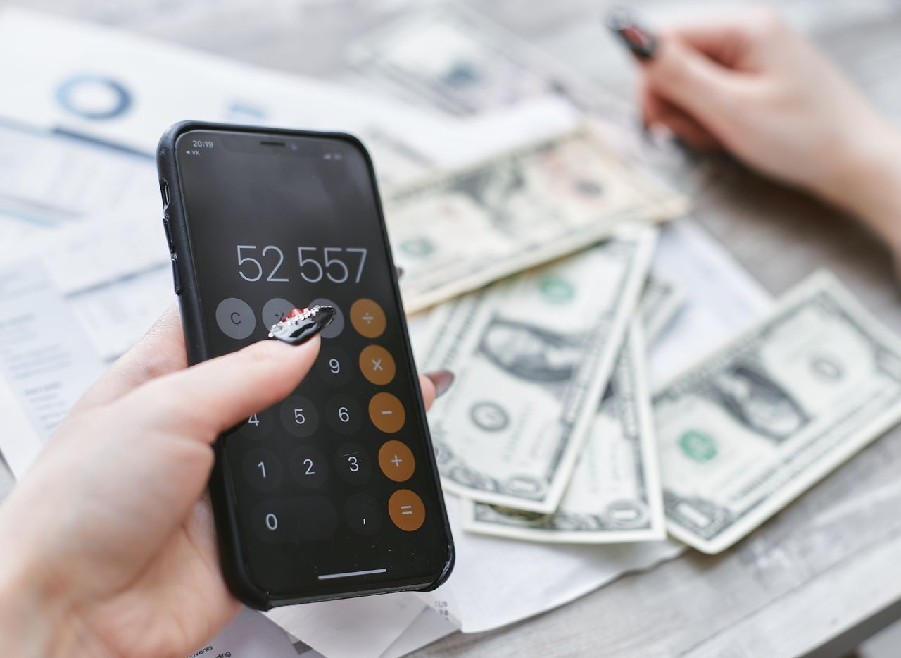 Close-up of a person holding a cellphone to find free ways to make money online
