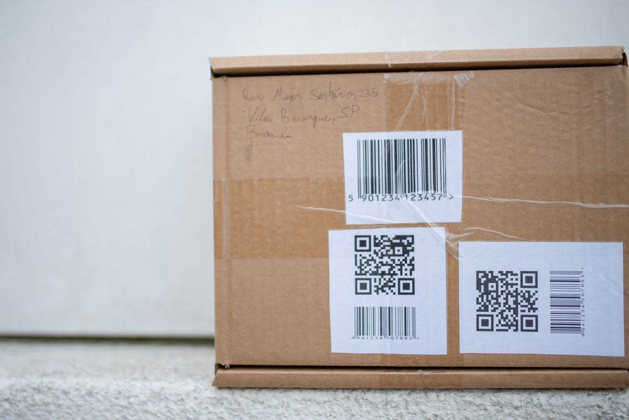 Close-up of a cardboard parcel with a barcode label used for USPS package tracking