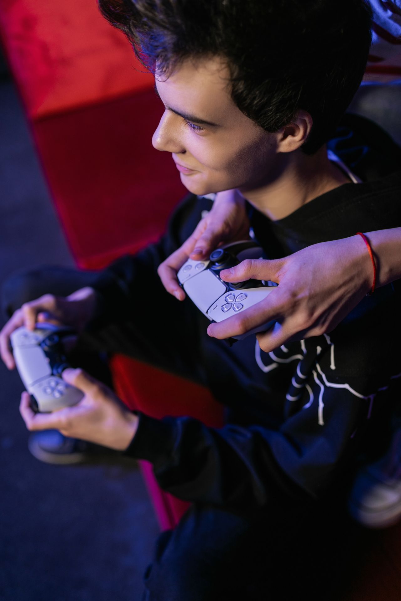 Man playing a video game with a controller, running GTA Online businesses and contracts for money