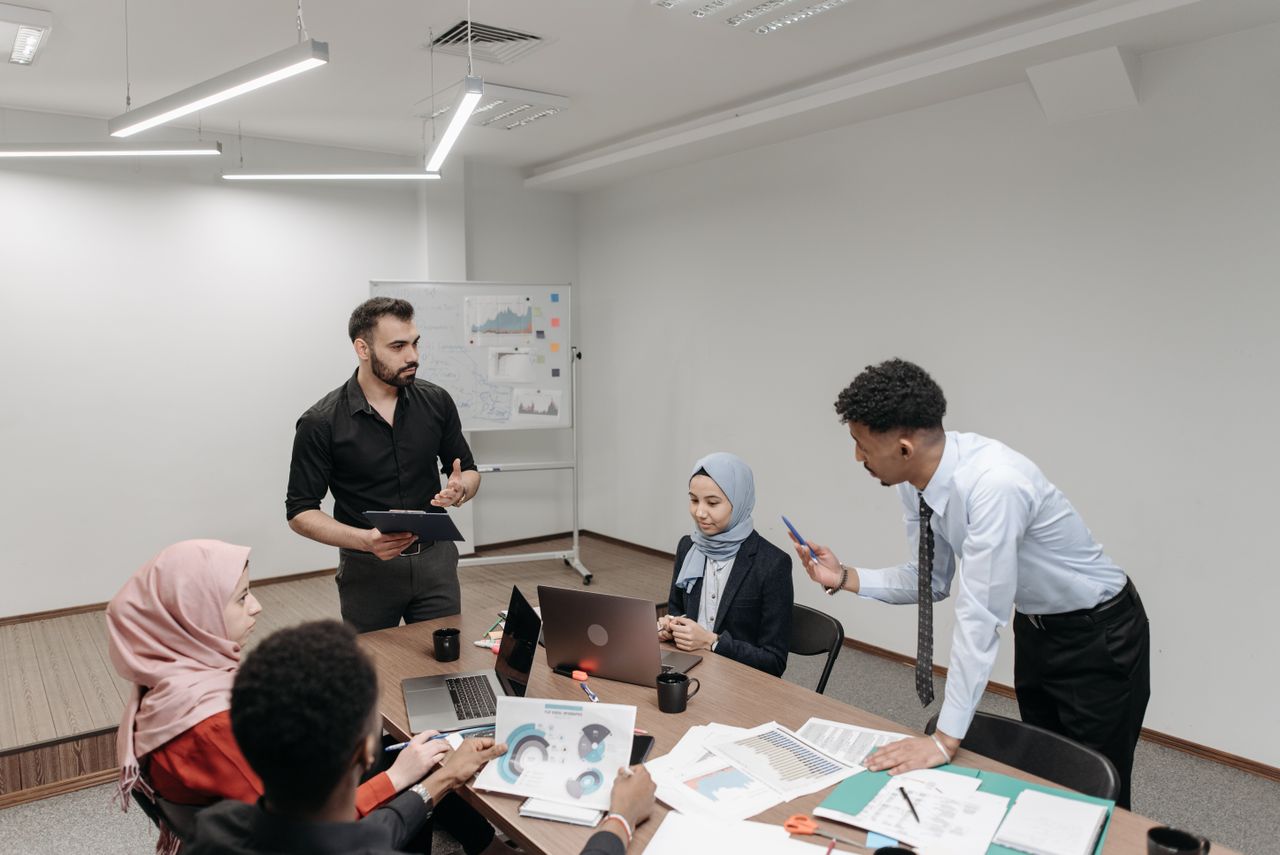 Group discussing in a conference room, like a paid focus group that pays more than online surveys for money