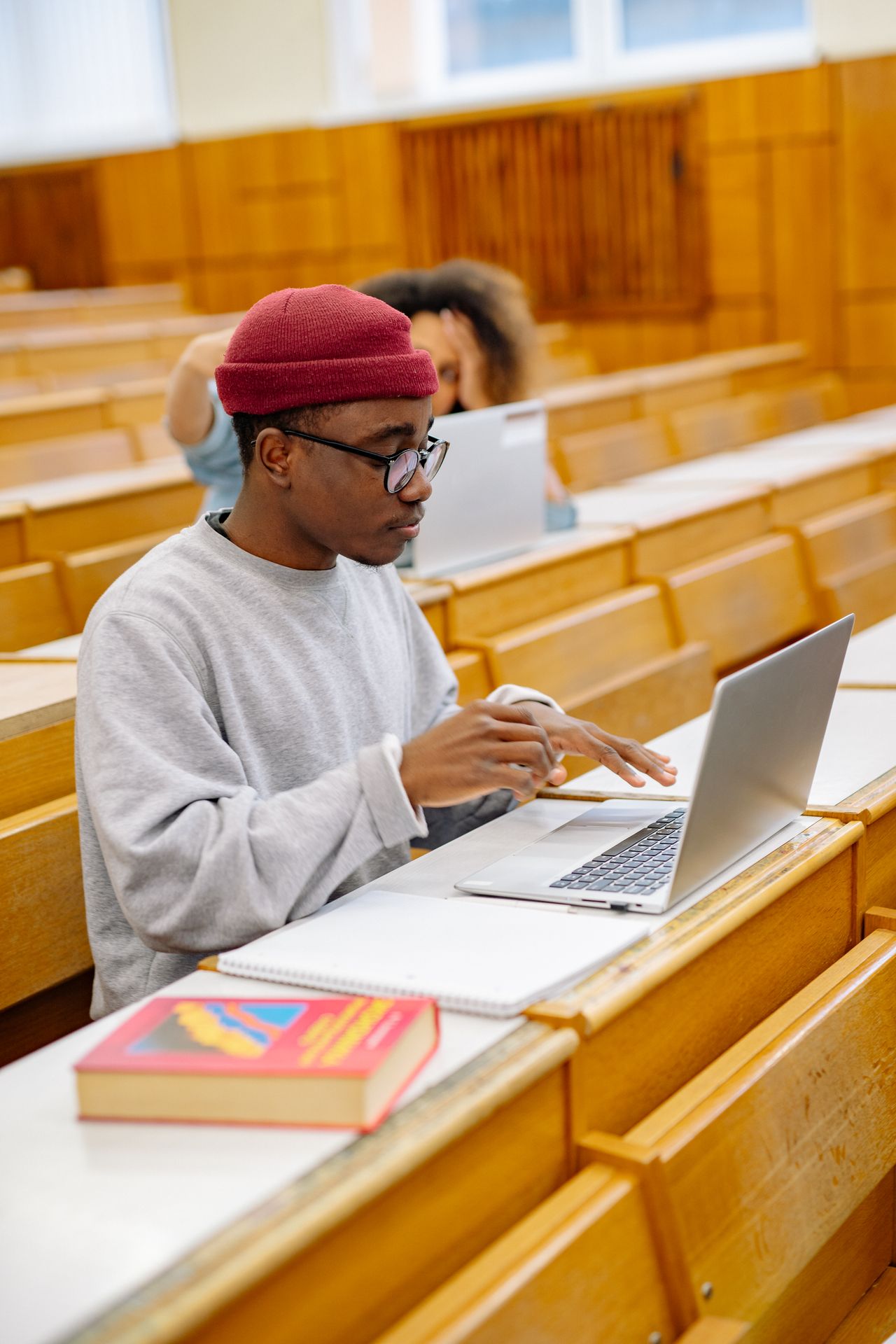 Student working on a laptop, checking that a student online job offer is not a scam