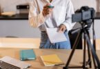 Creator recording content with a camera and laptop, the kind of seller a Sellfy review is written for