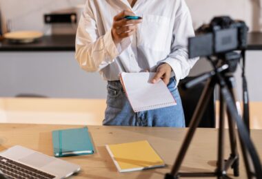 Creator recording content with a camera and laptop, the kind of seller a Sellfy review is written for