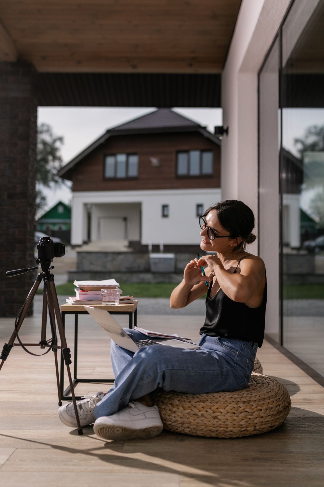 Creator reviewing photos on a laptop next to a camera, a typical ConvertKit (Kit) newsletter user