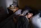 Man resting in bed in morning light, the dream behind ideas to make money while you sleep