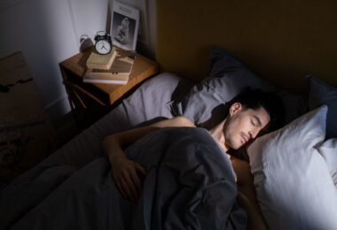Man resting in bed in morning light, the dream behind ideas to make money while you sleep